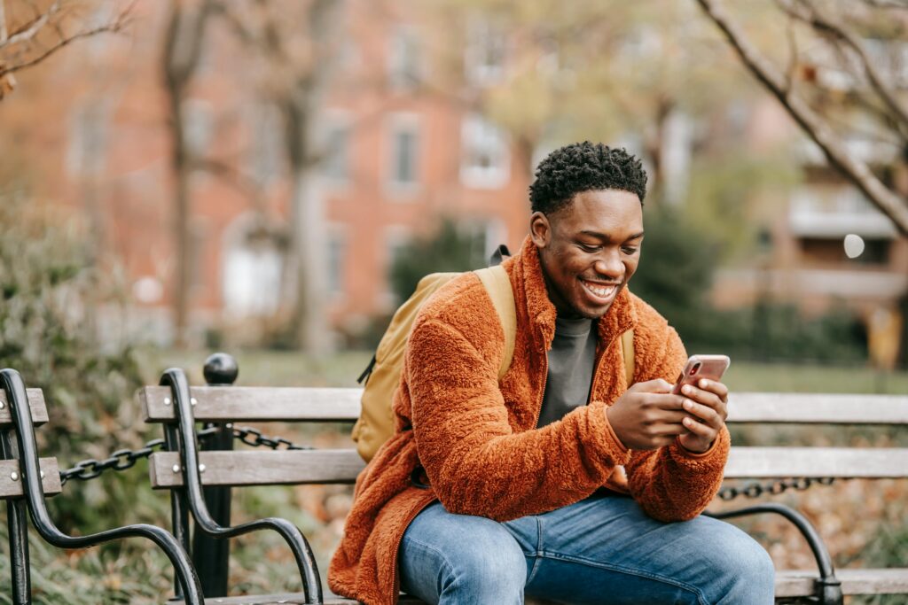 Photo by Keira Burton: https://www.pexels.com/photo/delightful-african-american-man-surfing-modern-cellphone-in-city-park-6146929/